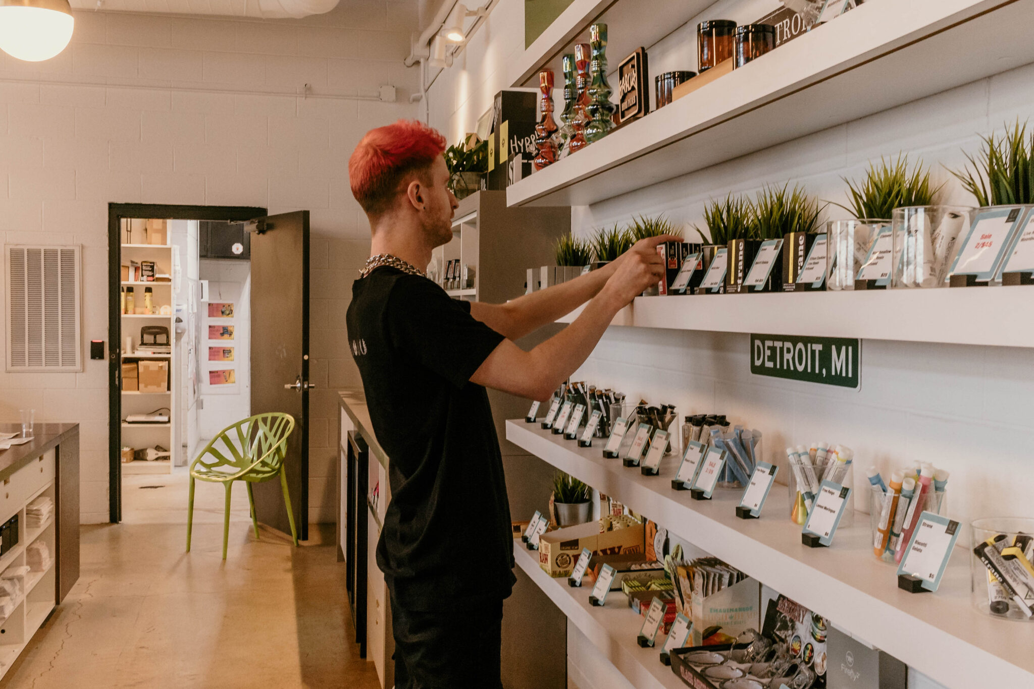 Employee setting up a display in Liberty's Detroit dispensary