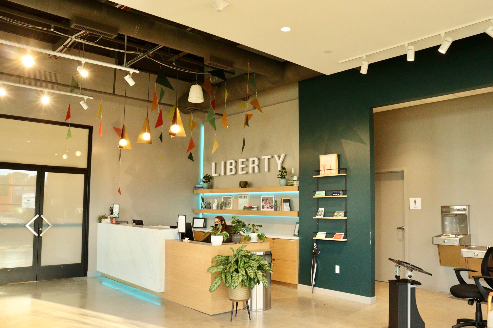 Liberty Madison Heights dispensary interior with employee at check-in desk